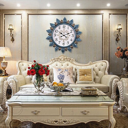 Koristeellinen seinäkello kultaisilla lehdillä