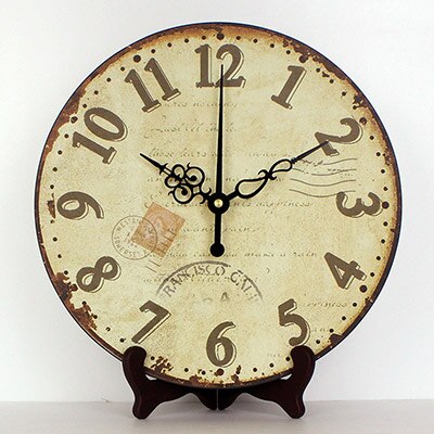 Pyöreä antiikkinen pöytäkello jalustalla