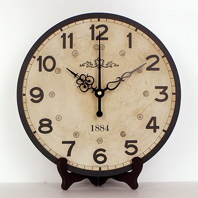 Pyöreä antiikkinen pöytäkello jalustalla