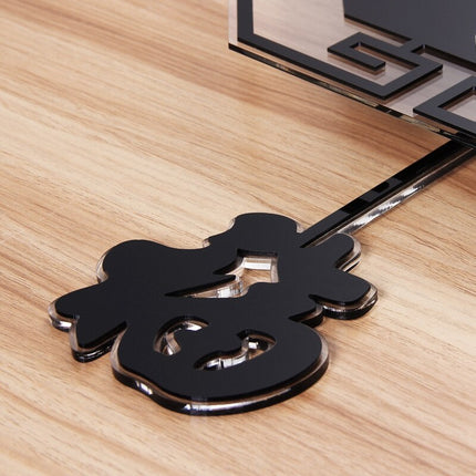 Musta kuusikulmainen seinäkello heilurilla